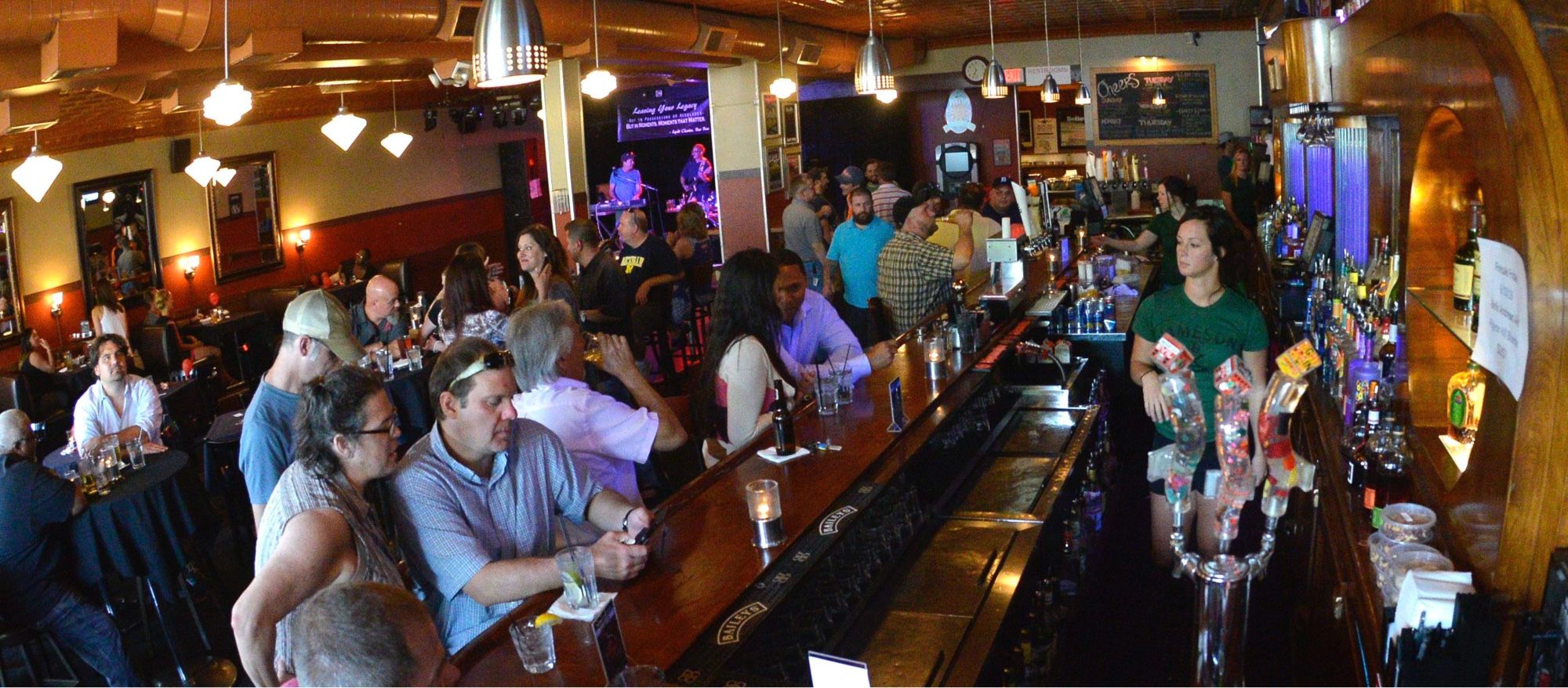 Interior of Billy's Lounge — dim lighting, stage, candlelit tables